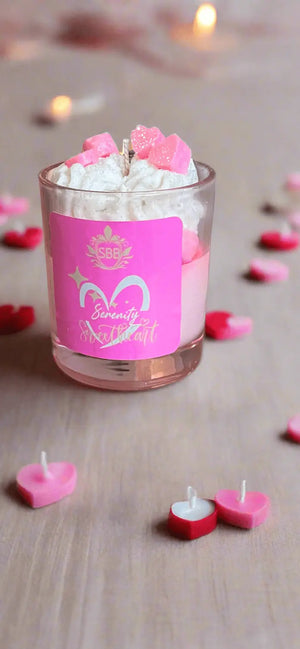 Valentine’s Day Serenity Sweetheart Candle in a glass jar, surrounded by pink and red heart-shaped candles.